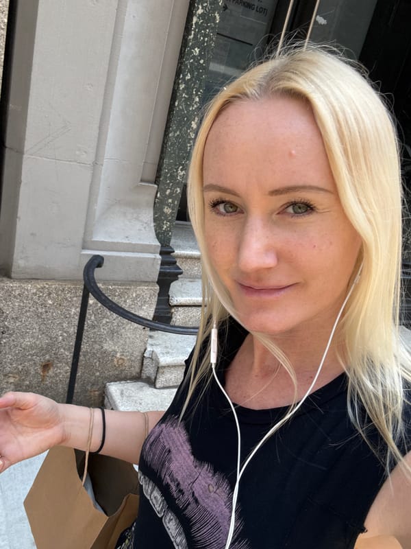 Woman with earphones spotted outside NYC parking lot building