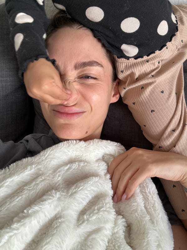 Woman rests on sofa with blanket in Kiel