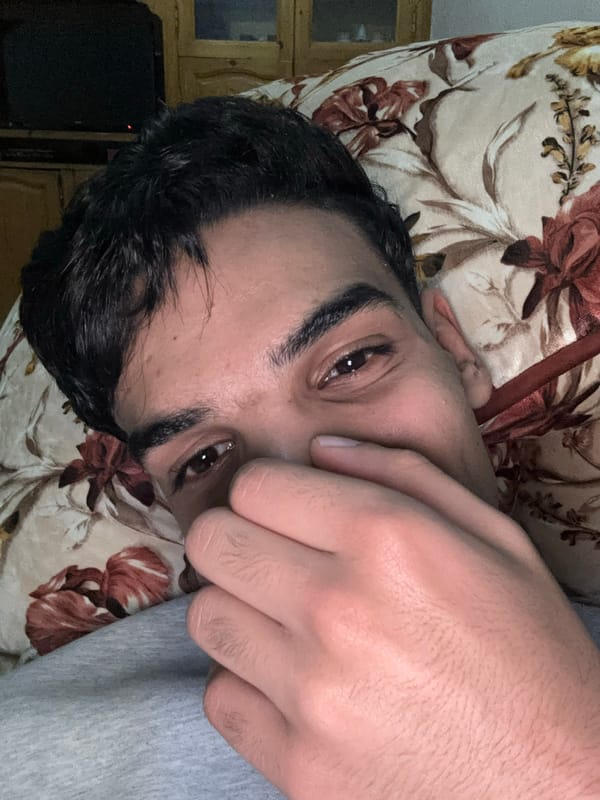 Man resting with hand over face in Fez