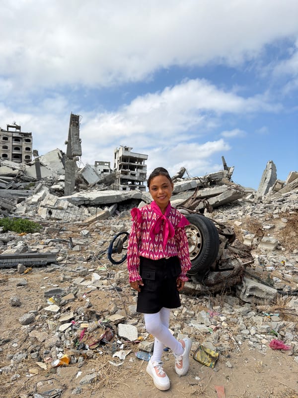 Girl and man witnessed among building rubble in Gaza City