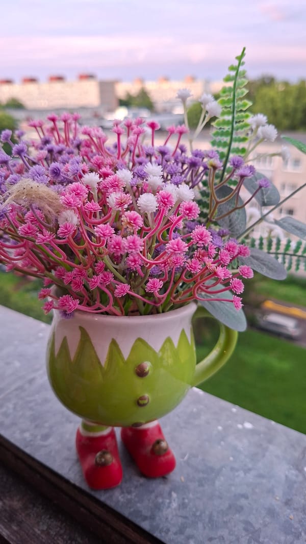 Tallinn evening: pastel skies, bokeh blooms, and a charming ceramic figurine