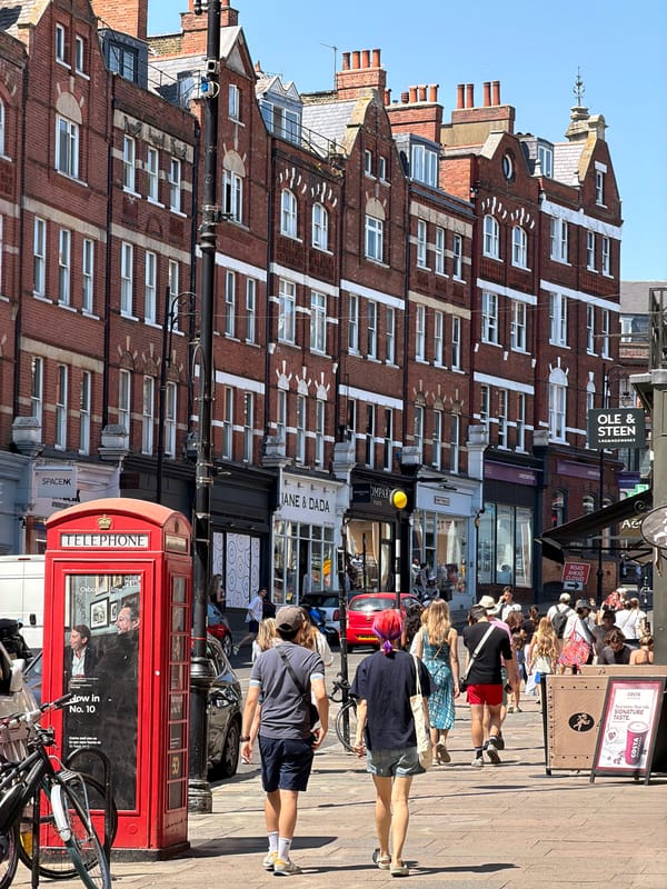 Red phone box on a sunny London street corner