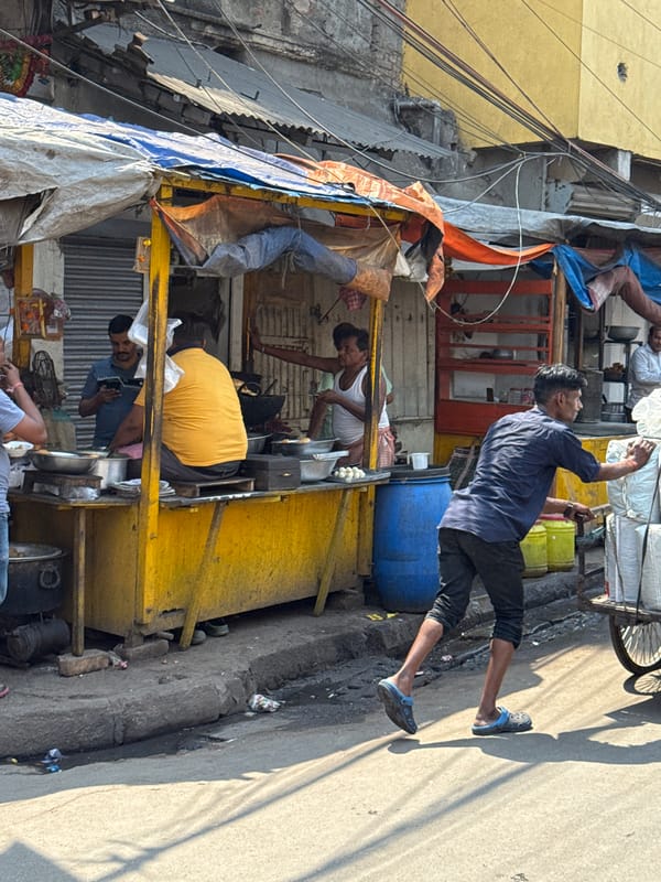 Morning street commerce and delivery activity in Kolkata