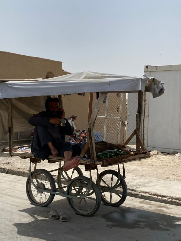 Kandahar street vendors and traffic on a July morning