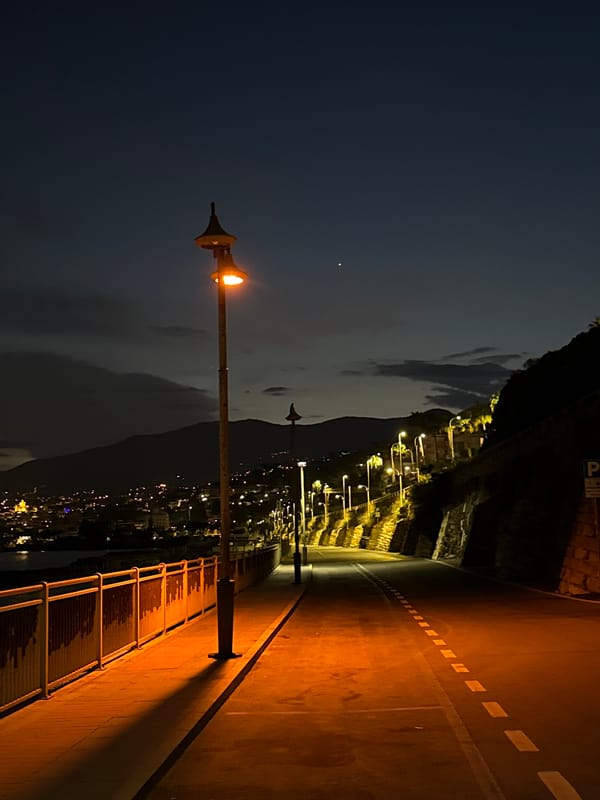 Evening stroll documented along Sanremo's illuminated coastal promenade