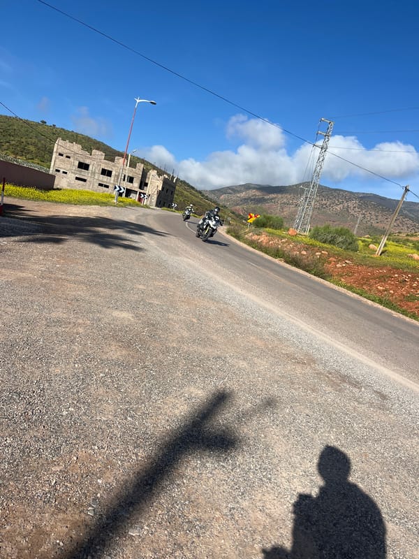 Motorcyclists travel winding road near Ouaouizert, Morocco