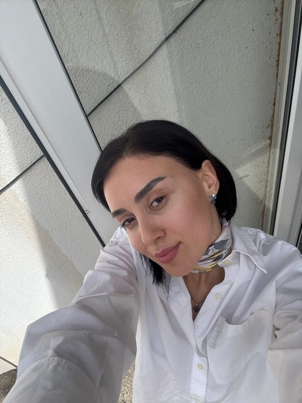 Woman takes selfies in downtown Tbilisi wearing cross necklace