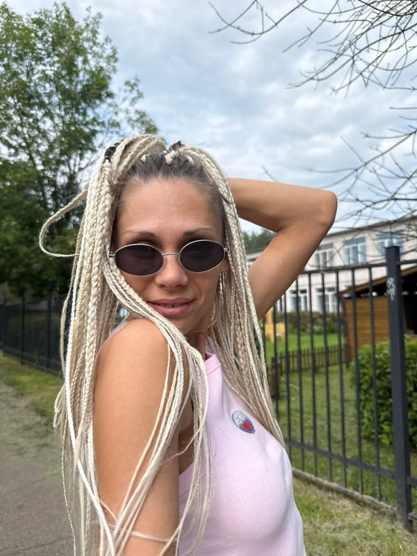 Outdoor portrait session near a metal fence in Rusanovo