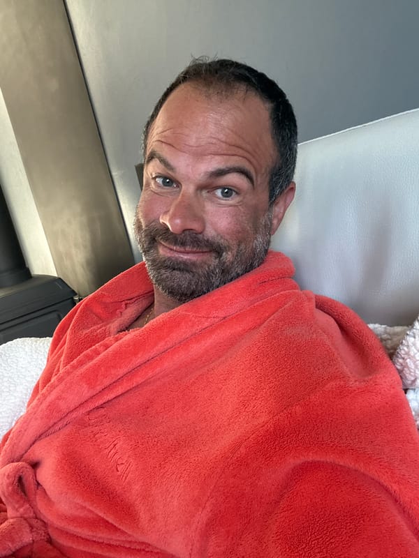 Man in orange robe photographed lying down in Belgium