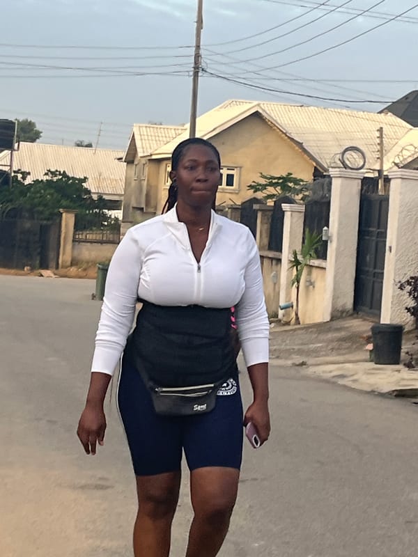 Early morning street activity on a paved road in Abuja