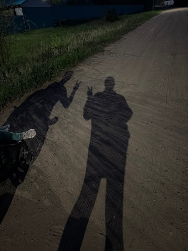 Two people meet on forest road in Chaikovsky at dusk