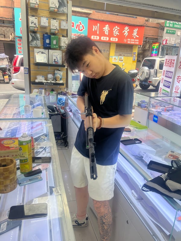 Armed Individual Photographed Inside Jiangjin Phone Shop
