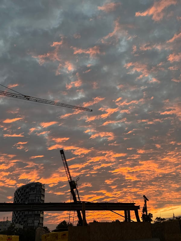 Full moon rises over a construction site at dusk