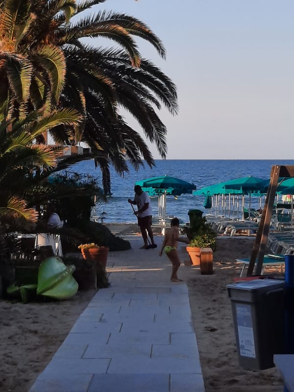 Afternoon at Pesaro's beachfront: cafés, bikes, and an Iron Man cutout
