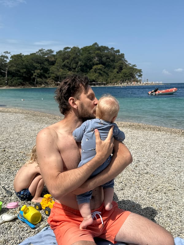 Father and child share beach moment in Fethiye