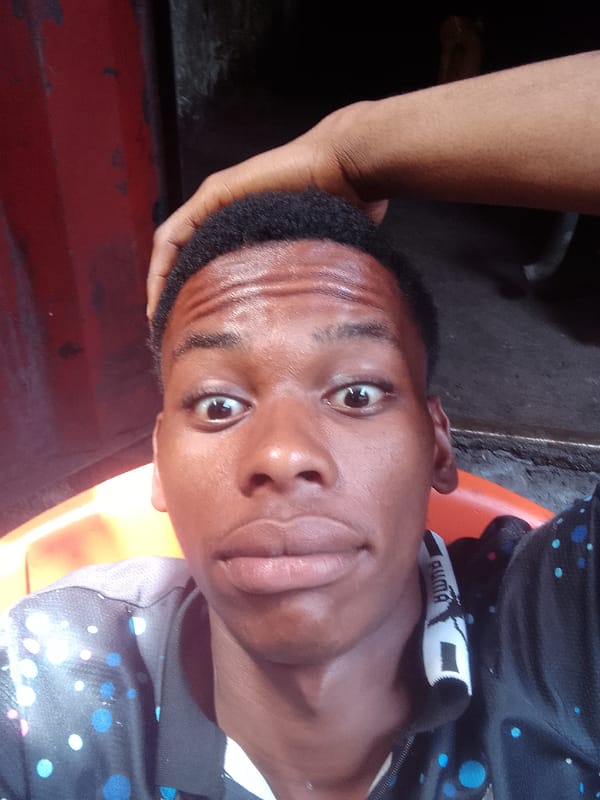 Young man takes playful selfies on Onitsha streets