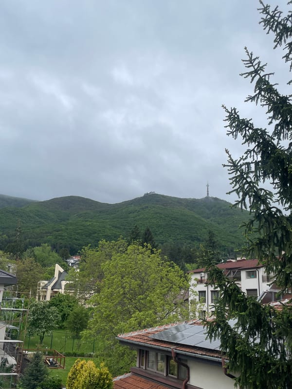 Mountain tower viewed from city under overcast skies