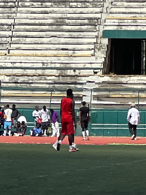 Football training session at a Nigerian stadium, mid-morning