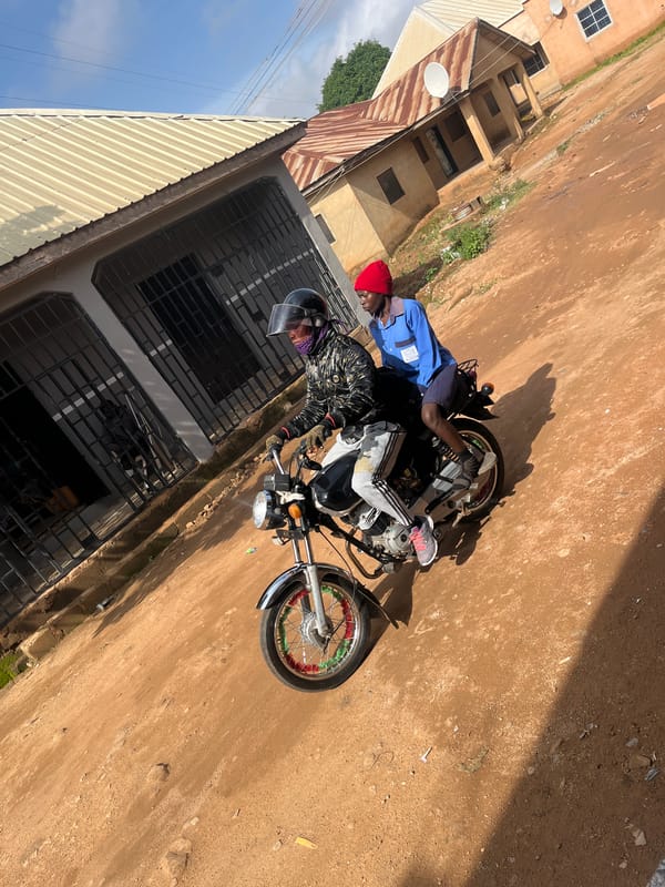 Morning street life on a dusty road in Gura Top, Nigeria