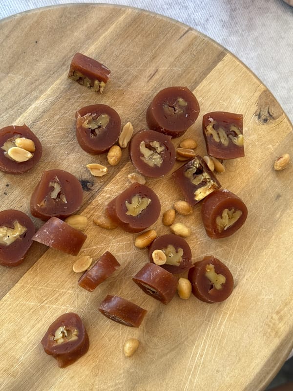 Dark candy pieces displayed on cutting board in Podgorica