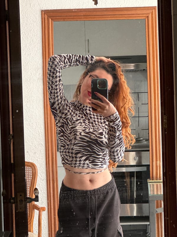 Mirror selfie captured in Barcelona showing person with red hair