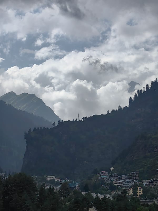 Kulang valley under monsoon clouds, river, villages, and construction