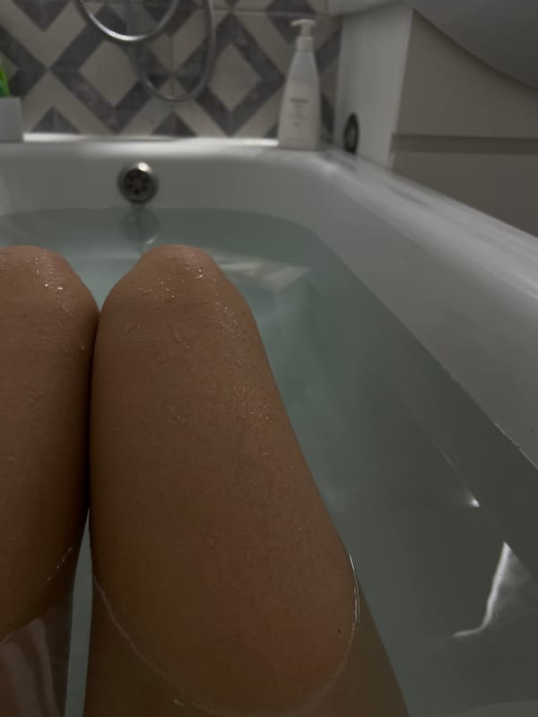 Person takes bath in geometric-tiled bathroom in Yoshkar-Ola