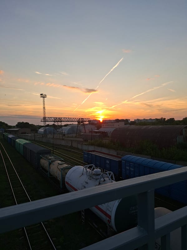 Sunset over Oral's freight yard, trains at rest
