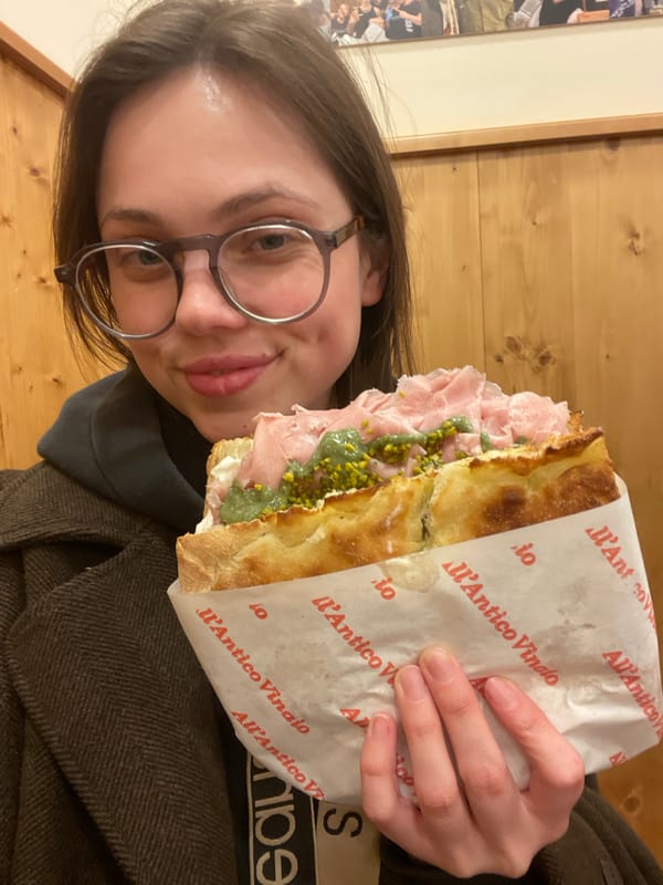 Woman enjoys focaccia sandwich at Naples eatery