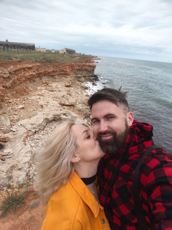 Couple shares tender moment at Sevastopol coastline amid spring flowers