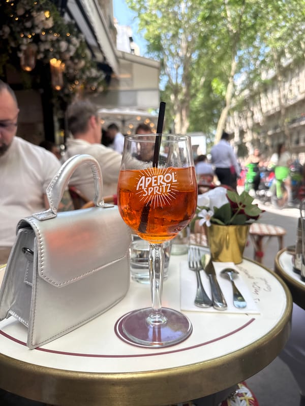 Paris cafe moment with Aperol Spritz and souvenir bear