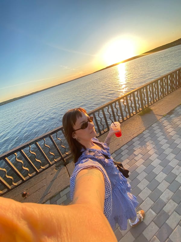 Woman takes sunset selfies at Votkinsk Reservoir waterfront