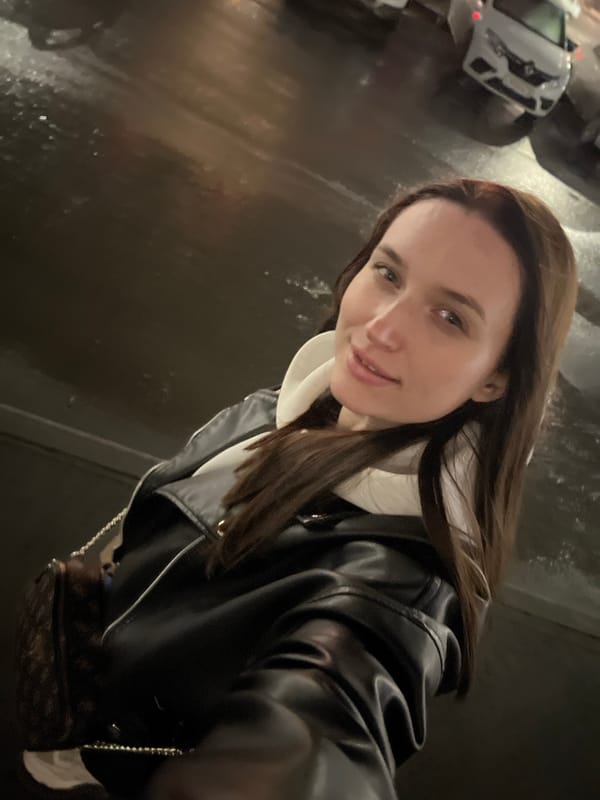 Woman takes nighttime selfies in rainy Tyumen street