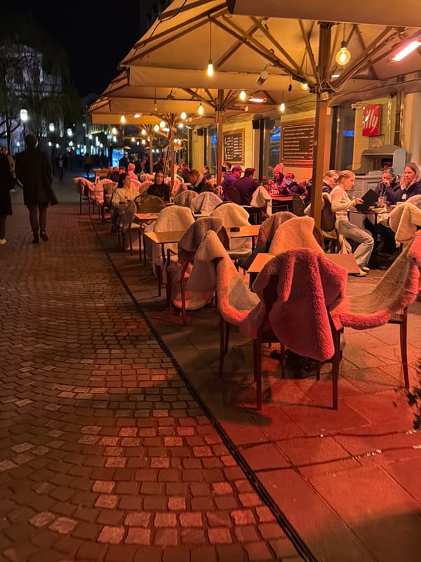 Evening dining scene captures Ljubljana's illuminated street cafes