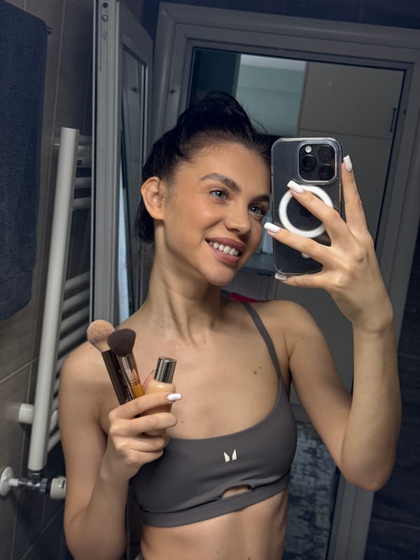 Woman takes morning selfie while doing makeup in Sofia