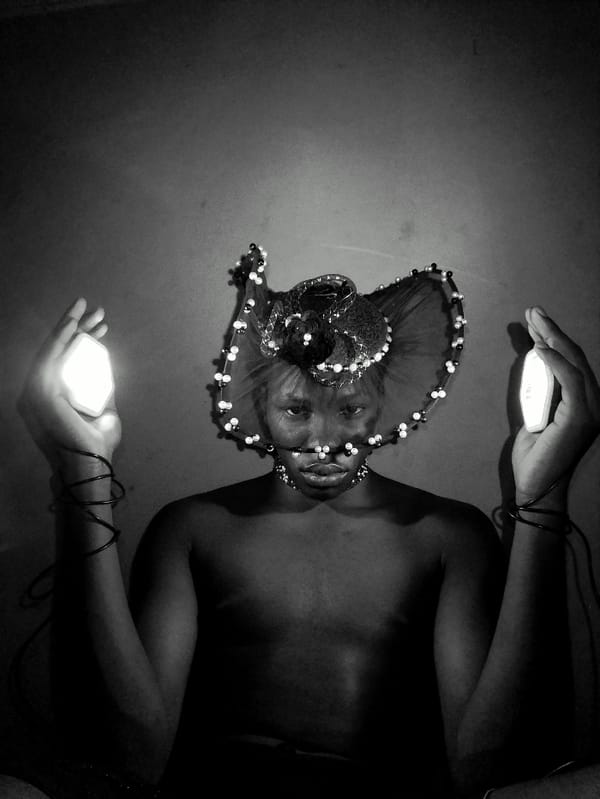 Artist conducts late-night portrait session with lights in Nigeria