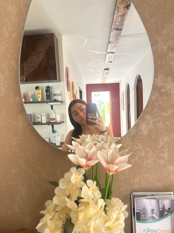 Woman takes mirror selfie in decorated Puebla home