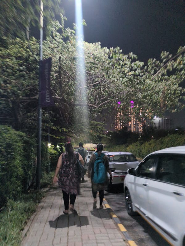 Nighttime street scenes captured in Bengaluru showing pedestrians and landscaping