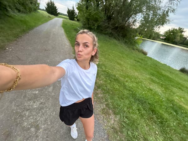 Woman takes selfie on path in Veauchette, France