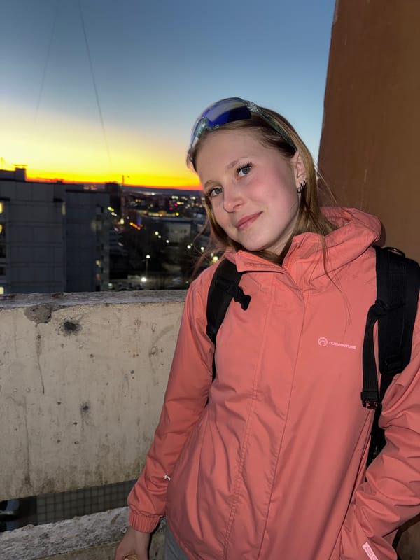 Woman enjoys ice cream on balcony at dusk in Chaikovsky