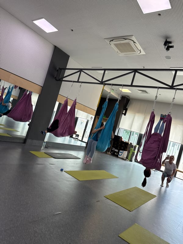 Aerial yoga session in a colorful hammock studio