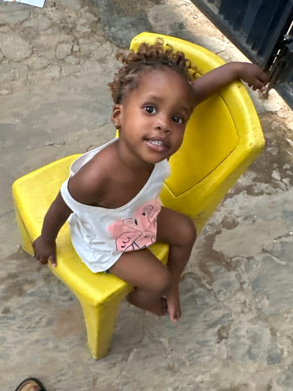 Children play on yellow plastic equipment in Narayi, Nigeria