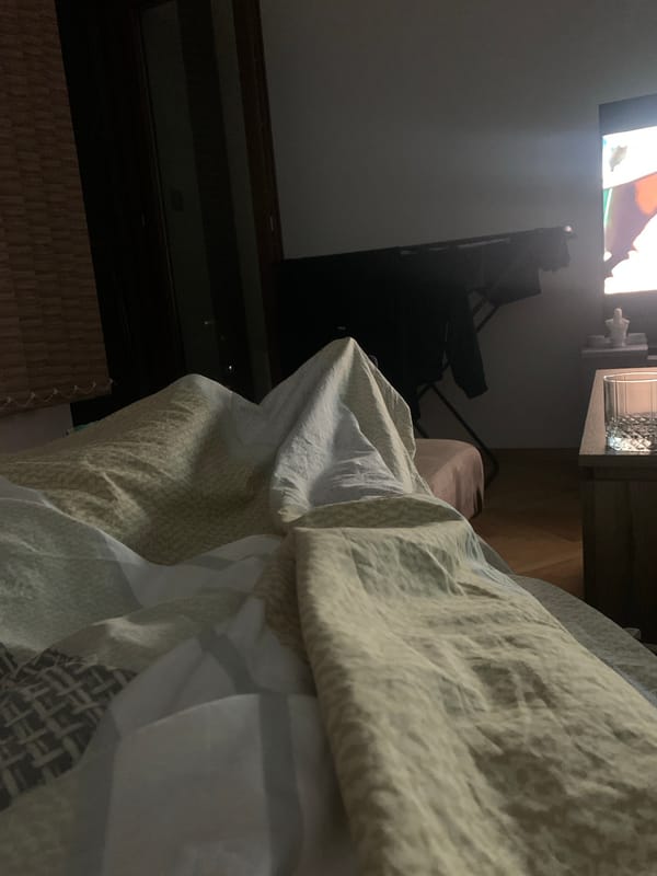 Bedroom interior with unmade bed captured by witness