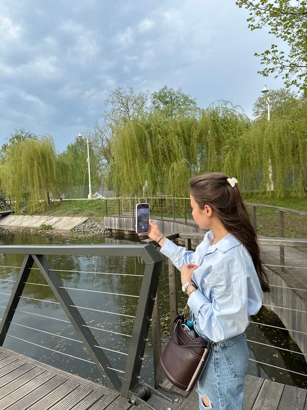 Woman photographed on wooden boardwalk over water in Moscow