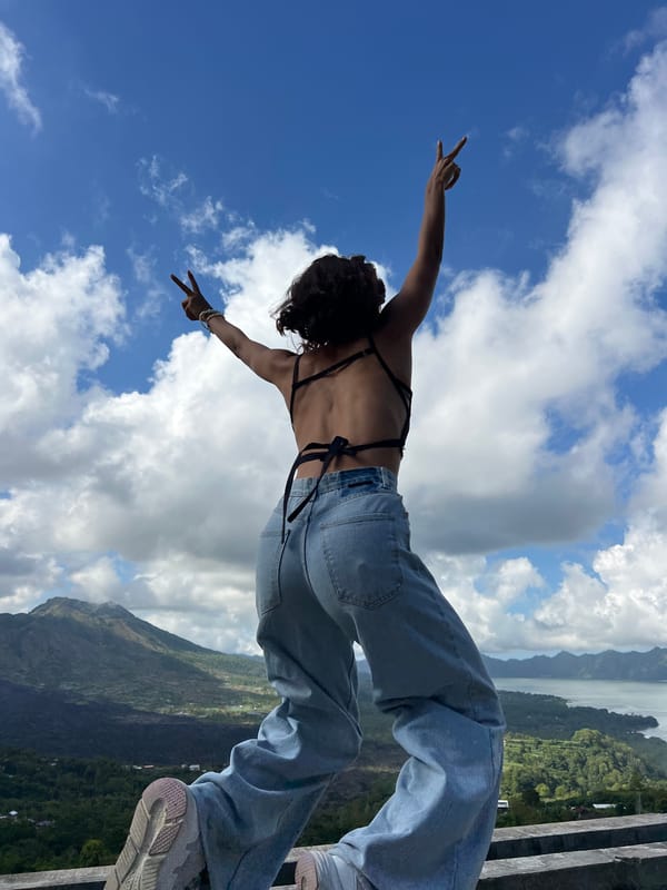 Tourist enjoys morning coffee and photos at Kintamani volcano overlook