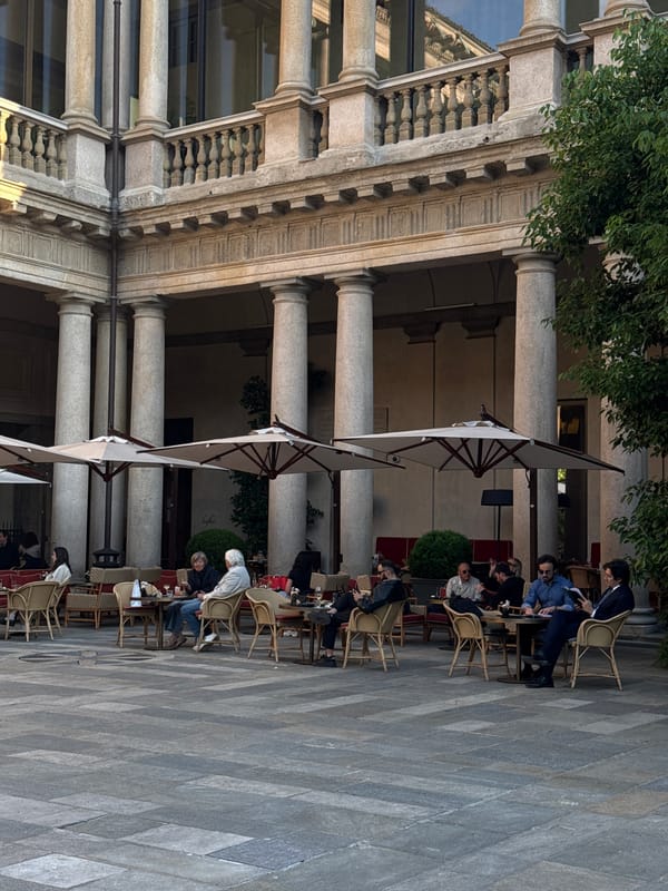 Afternoon dining scene captured at Milan's classical courtyard venue