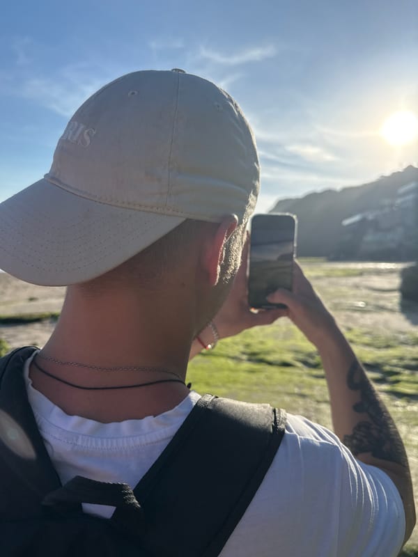 Morning beachgoers explore Kuta Selatan's rocky coastline