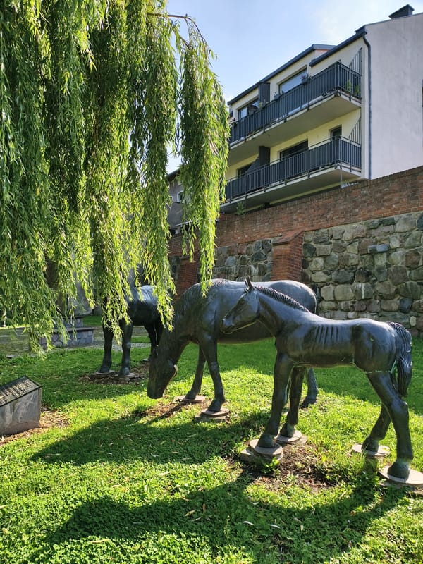 Church, lake, and outdoor sculptures in Sztum, Poland