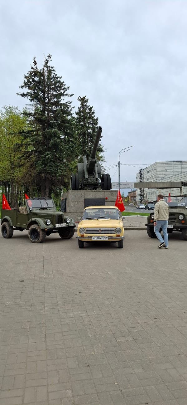 Family poses at military monument display in Klin, Russia