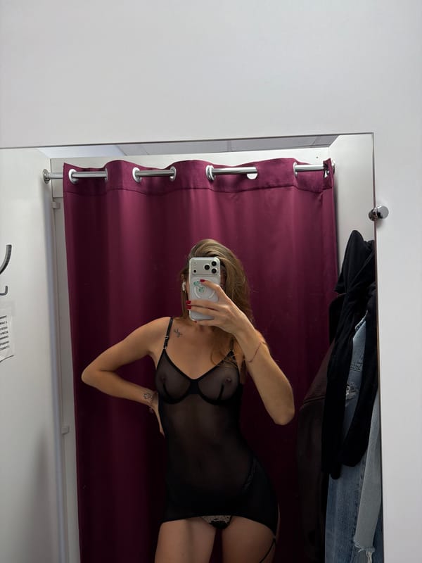Woman tries on clothing in Nakhodka dressing room